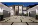 Well lit modern house featuring large drive, manicured lawn, and symmetrical design at dusk at 2161 Sharon Rd, Winter Park, FL 32789