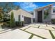 A modern residence showcased with an expansive paved driveway framed by manicured greenery at 2161 Sharon Rd, Winter Park, FL 32789