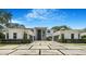 Stunning modern home featuring a grand entrance and meticulously landscaped front yard with paver driveway at 2161 Sharon Rd, Winter Park, FL 32789