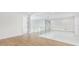 Bright foyer area with hardwood floors, glass railings and access to multiple rooms at 2161 Sharon Rd, Winter Park, FL 32789