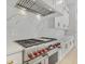 Gourmet kitchen features a high-end range, stone backsplash, and custom cabinetry at 2161 Sharon Rd, Winter Park, FL 32789