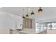 Modern kitchen boasts waterfall island, stainless appliances, and stylish pendant lighting at 2161 Sharon Rd, Winter Park, FL 32789