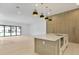 Modern kitchen boasts waterfall island, stainless appliances, and stylish pendant lighting at 2161 Sharon Rd, Winter Park, FL 32789