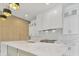 Bright, modern kitchen features a large island, stainless appliances, and white cabinets at 2161 Sharon Rd, Winter Park, FL 32789