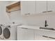 Laundry room features modern appliances, countertops, sink, and stylish cabinets at 2161 Sharon Rd, Winter Park, FL 32789
