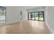 Bright living room features modern flooring, large windows and backyard pool view at 2161 Sharon Rd, Winter Park, FL 32789