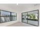 Bright living room features clean, white walls and light flooring with sliding doors leading to an outdoor patio at 2161 Sharon Rd, Winter Park, FL 32789