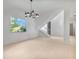 Modern living room showcasing a staircase, large windows, and sleek design at 2161 Sharon Rd, Winter Park, FL 32789