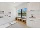 Bright mudroom with a window, built-in shelving, sink, and sleek cabinets at 2161 Sharon Rd, Winter Park, FL 32789