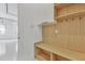 Mudroom with built-in bench, shelving, hooks, and cabinet storage at 2161 Sharon Rd, Winter Park, FL 32789