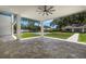 Spacious covered patio area offers views of the pool, manicured lawn, landscaping, and outdoor entertaining possibilities at 2161 Sharon Rd, Winter Park, FL 32789