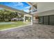 Covered outdoor patio with a built-in grill, fan, and a spacious backyard with a pool and guest house at 2161 Sharon Rd, Winter Park, FL 32789