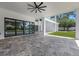 Large covered patio with contemporary stone flooring offering view of pool, modern home design, and green landscaping at 2161 Sharon Rd, Winter Park, FL 32789