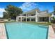 Inviting backyard featuring a modern pool, expansive manicured lawn, and an elegant home exterior at 2161 Sharon Rd, Winter Park, FL 32789