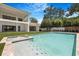 Inviting pool and spa featuring modern design and landscaping complemented by the home's architectural details at 2161 Sharon Rd, Winter Park, FL 32789