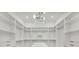 Spacious walk-in closet with ample shelving and a modern chandelier at 2161 Sharon Rd, Winter Park, FL 32789