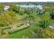 An aerial view of the playground and surrounding landscaping by the lake at 4008 Versailles Dr # 4008C, Orlando, FL 32808