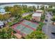 Aerial view of the community tennis courts near a lake and residential buildings at 4008 Versailles Dr # 4008C, Orlando, FL 32808