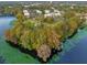 An aerial view of the condos, and surrounding landscaping by the lake at 4008 Versailles Dr # 4008C, Orlando, FL 32808