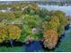 An aerial view of the lake with trees, landscaping and walking paths at 4008 Versailles Dr # 4008C, Orlando, FL 32808