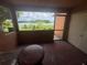 Enclosed balcony featuring scenic views of the lake and surrounding greenery at 4008 Versailles Dr # 4008C, Orlando, FL 32808