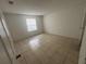 Empty bedroom with tile flooring and natural light at 4008 Versailles Dr # 4008C, Orlando, FL 32808