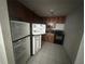 Kitchen featuring standard appliances and dark wood cabinets at 4008 Versailles Dr # 4008C, Orlando, FL 32808