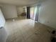 Spacious living room with tile flooring and sliding glass doors leading to the balcony at 4008 Versailles Dr # 4008C, Orlando, FL 32808
