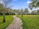 A paved walking path and landscaping provide a great outdoor experience at 4008 Versailles Dr # 4008C, Orlando, FL 32808