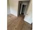 View of the room shows plywood flooring with blank walls and a closet at 4121 Dijon Dr # 4121H, Orlando, FL 32808