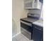 Close-up view of the black and stainless steel stove and microwave with marble countertop detail at 4121 Dijon Dr # 4121H, Orlando, FL 32808