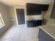 This kitchen features dark cabinets, stainless steel sink, and white countertops, with light tile floors at 4121 Dijon Dr # 4121H, Orlando, FL 32808