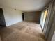 Living room with sliding glass doors, and a large window for plenty of natural light at 4121 Dijon Dr # 4121H, Orlando, FL 32808