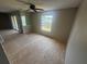 Living room with sliding glass doors, large window for natural light, and ceiling fan at 4121 Dijon Dr # 4121H, Orlando, FL 32808