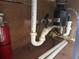 View of under-sink pipes with disposal system and a fire extinguisher nearby at 4121 Dijon Dr # 4121H, Orlando, FL 32808
