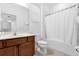 Bright bathroom featuring a vanity, toilet, and shower-tub combo with white shower curtain at 4501 Monado Dr, Kissimmee, FL 34746