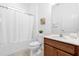 Clean bathroom with a shower and tub combo, modern vanity, and neutral tiling at 4501 Monado Dr, Kissimmee, FL 34746