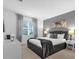 Comfortable bedroom featuring a queen bed with stylish gray accents and ample natural light at 4501 Monado Dr, Kissimmee, FL 34746