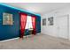 Bright bedroom featuring red curtains, a small table with two chairs, and custom paint at 4501 Monado Dr, Kissimmee, FL 34746