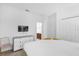 Bright bedroom with a closet, television, plush carpet, and a view into an attached bathroom at 4501 Monado Dr, Kissimmee, FL 34746