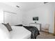Well-lit bedroom with a closet, television, plush carpet and a gray accent chair at 4501 Monado Dr, Kissimmee, FL 34746
