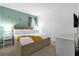 Inviting bedroom with soft carpet, a stylish bed, and a soothing teal accent wall at 4501 Monado Dr, Kissimmee, FL 34746