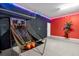 Vibrant game room featuring a basketball arcade, perfect for entertainment with colorful neon lights at 4501 Monado Dr, Kissimmee, FL 34746