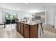 Open-concept kitchen with granite countertops, an island, and seamless connection to the dining and living area at 4501 Monado Dr, Kissimmee, FL 34746