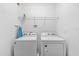 Functional laundry room featuring a washer, dryer, and overhead shelving for storage at 4501 Monado Dr, Kissimmee, FL 34746