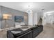 Contemporary living room with a large sectional sofa, television, and staircase at 4501 Monado Dr, Kissimmee, FL 34746