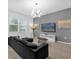 Comfortable living room with a large couch, television, and plenty of natural light at 4501 Monado Dr, Kissimmee, FL 34746