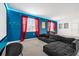 Cozy media room with a plush sectional, large screen, and red curtains for a cinematic atmosphere at 4501 Monado Dr, Kissimmee, FL 34746
