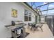 Covered patio with BBQ grill and seating area, ideal for outdoor cooking and relaxing at 4501 Monado Dr, Kissimmee, FL 34746