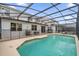 Enclosed backyard pool with a screened patio, BBQ area, and lounge chairs for luxury outdoor living at 4501 Monado Dr, Kissimmee, FL 34746